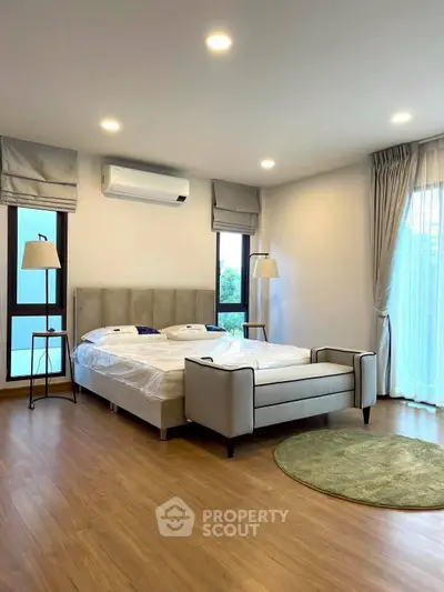 Spacious bedroom with modern decor and natural light