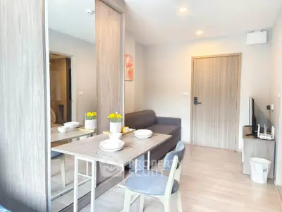 Modern living room with dining area in a stylish apartment, featuring contemporary furniture and elegant decor.