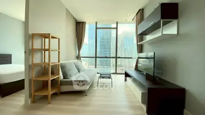 Modern living room with city view, stylish furniture, and natural light