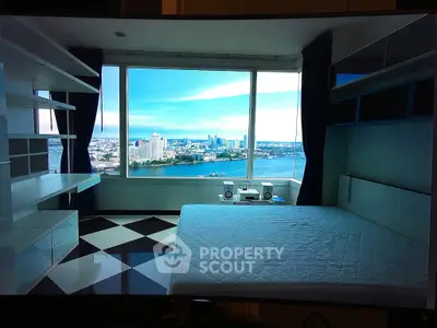 Stunning bedroom with panoramic city and river views, featuring modern design and ample natural light.