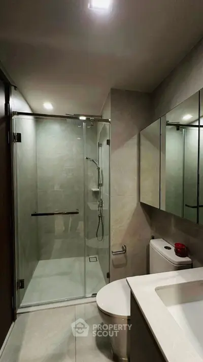 Modern bathroom with glass shower and sleek fixtures