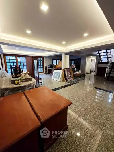 Spacious interior with modern lighting and polished flooring, ideal for versatile living or office space.