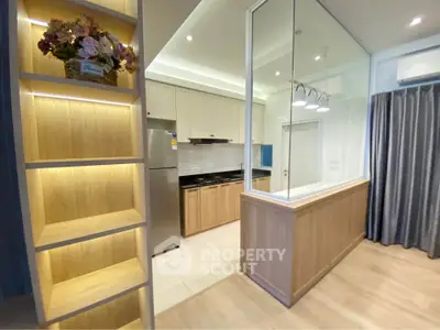 Modern kitchen with sleek design, featuring stainless steel appliances and elegant lighting.
