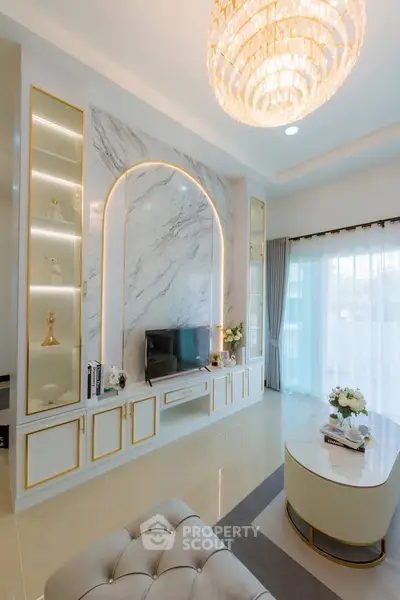 Luxurious living room with elegant chandelier and marble accent wall