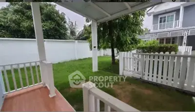 Charming garden view from a cozy porch in a suburban home