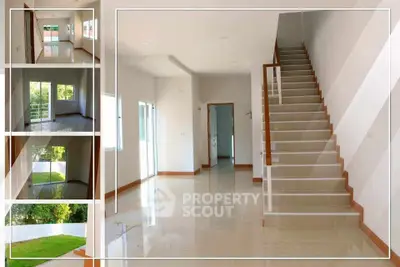 Spacious modern home interior with elegant staircase and large windows for natural light.
