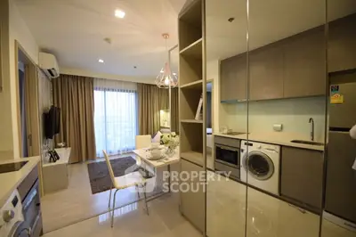 Modern open-plan kitchen and dining area with stylish decor and natural light.