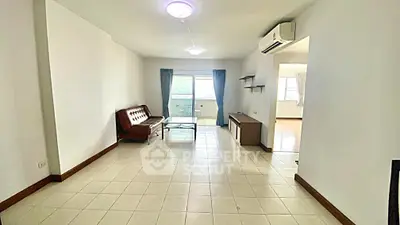 Spacious living room with modern furniture and balcony view in a bright apartment.