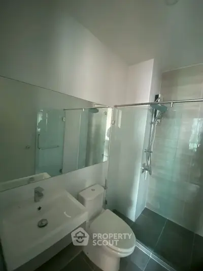 Modern bathroom with sleek fixtures and glass shower enclosure
