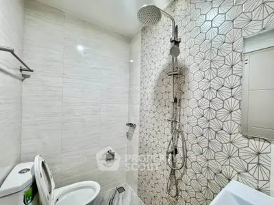 Modern bathroom with stylish geometric tiles and rainfall showerhead