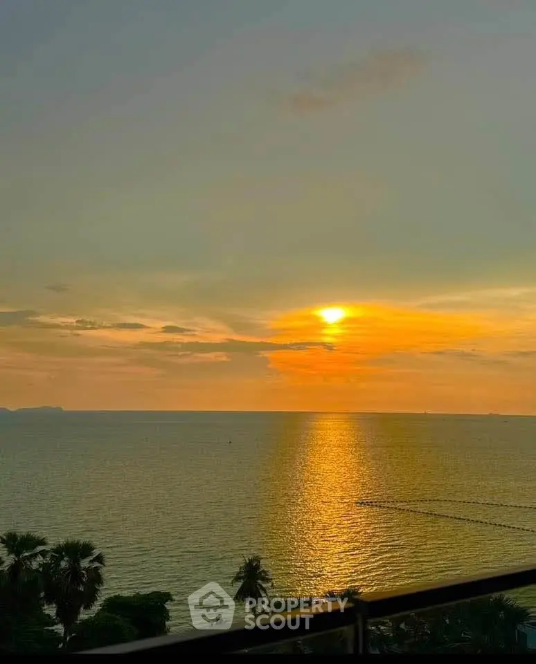 Stunning ocean view from a high-rise balcony at sunset, perfect for serene living.