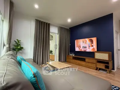 Modern living room with stylish decor, featuring a cozy sofa, wooden TV stand, and vibrant accent wall.