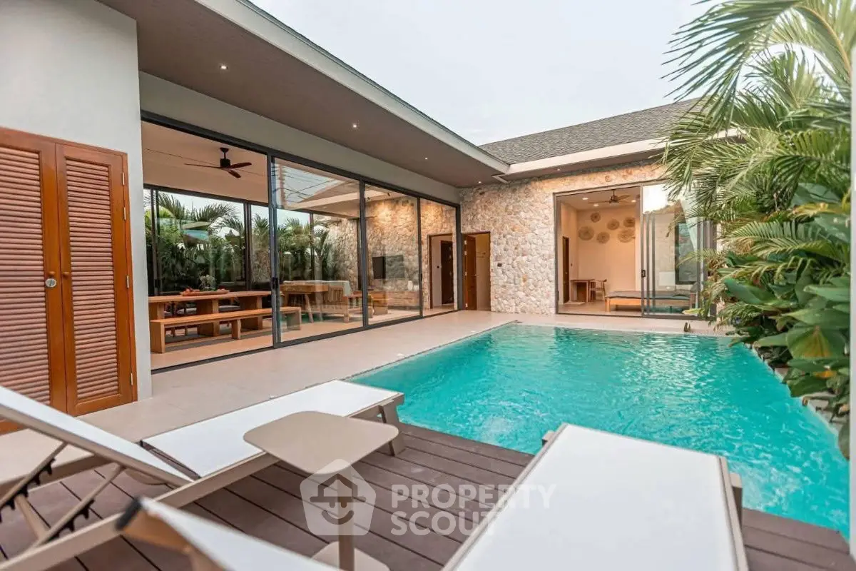 Luxurious villa with private pool and modern outdoor seating area.