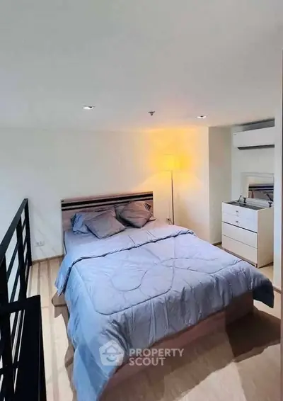 Cozy bedroom with modern decor and ample natural light, featuring a comfortable bed and stylish furnishings.