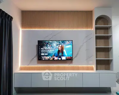 Modern living room with stylish TV wall unit and ambient lighting