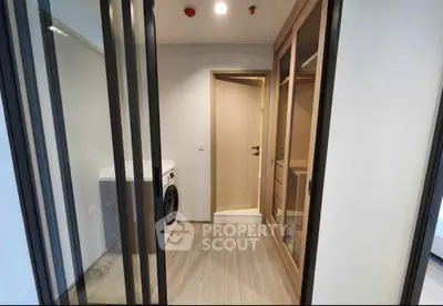 Modern laundry room with sleek design and washing machine in a stylish apartment.