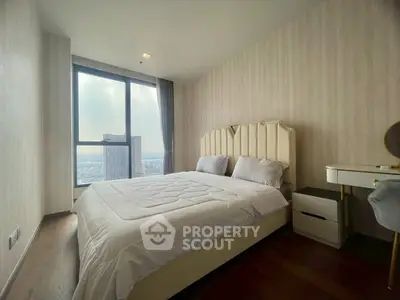 Modern bedroom with large window offering stunning city view