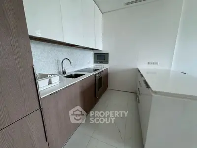 Modern kitchen with sleek cabinetry and built-in appliances in a contemporary home.