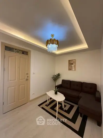Modern living room with stylish lighting and cozy seating area.