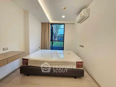 Modern bedroom with large window and air conditioning unit