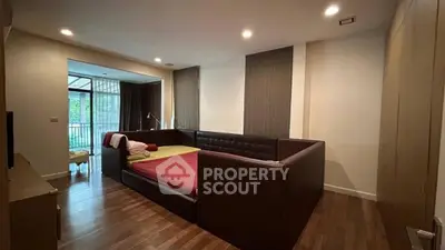 Spacious bedroom with modern design and large windows offering natural light.