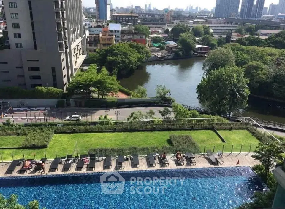 Stunning rooftop pool with lush greenery and cityscape view, perfect for relaxation and urban living.