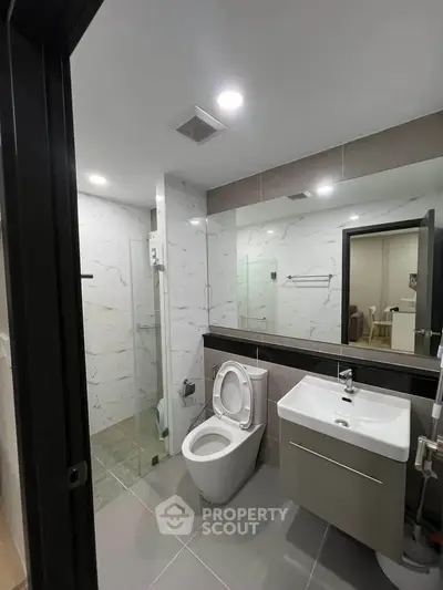 Modern bathroom with sleek fixtures and glass shower enclosure