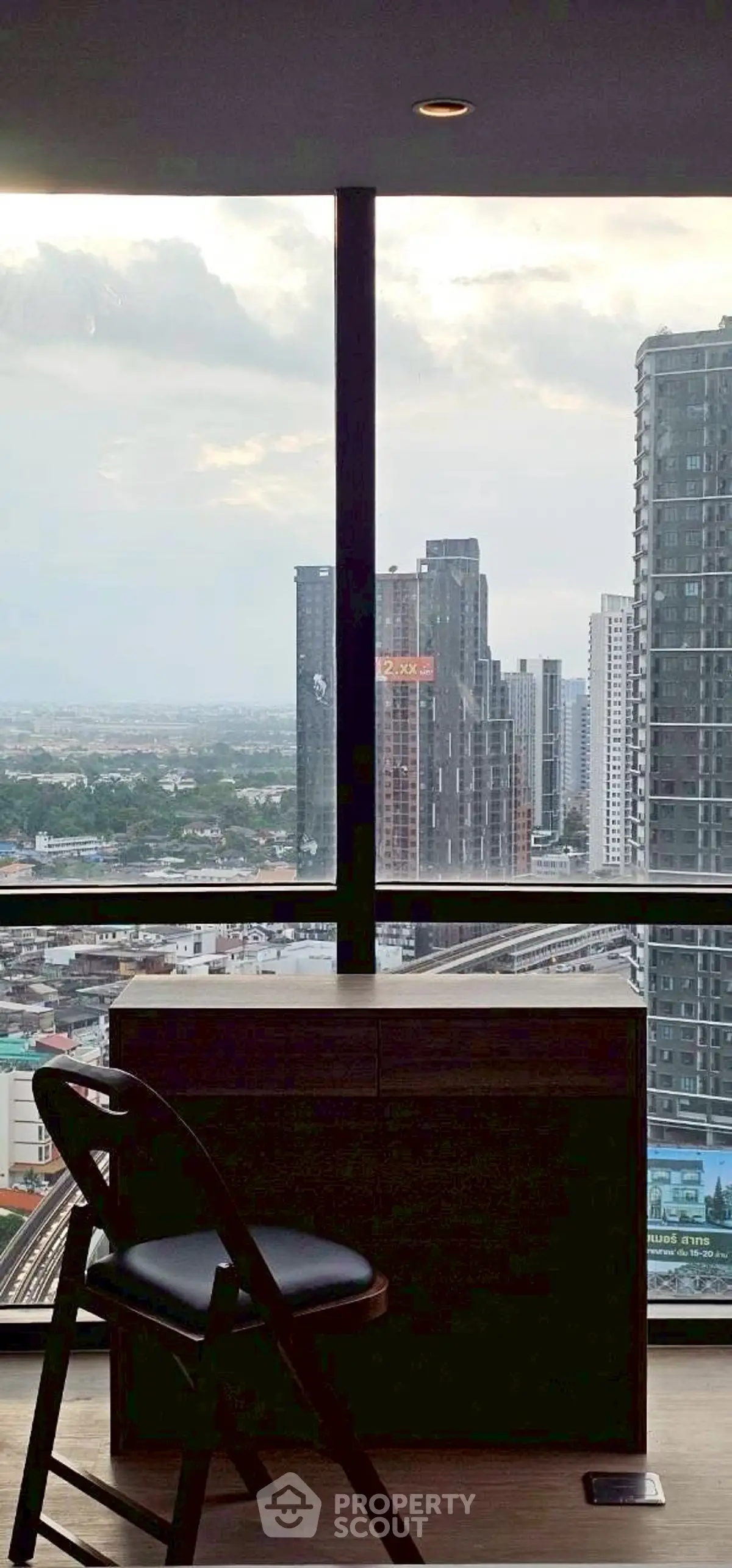 Stunning high-rise view from modern apartment with floor-to-ceiling windows.