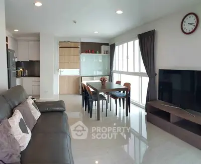 Spacious modern living room with sleek furniture and large windows for natural light.