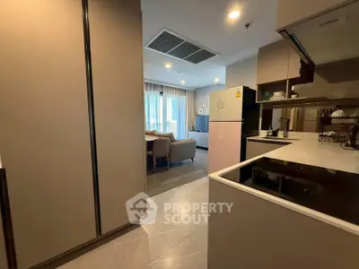 Modern open-layout kitchen with sleek cabinetry and dining area, perfect for contemporary living.
