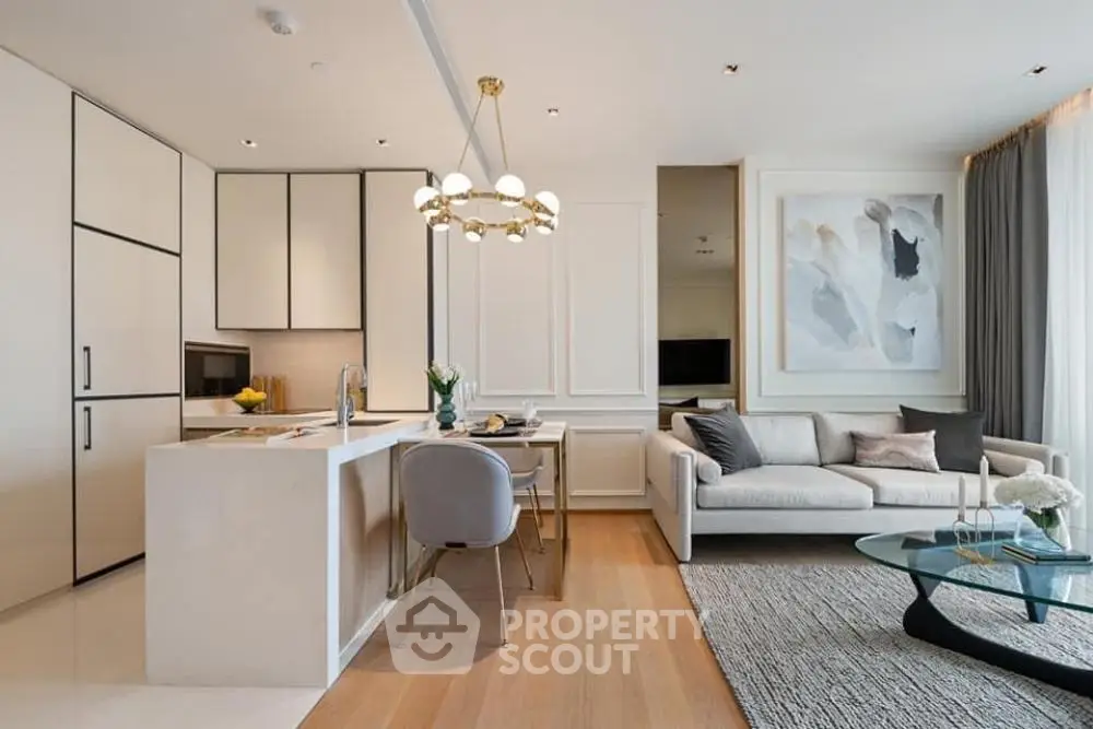 Luxurious open-plan living room and kitchen with modern decor and elegant lighting.