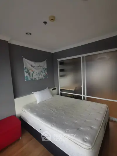 Cozy bedroom with modern decor and ample natural light