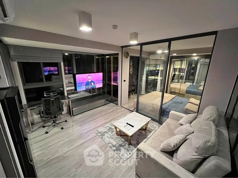 Modern living room with glass partition, cozy sofa, and stylish decor in a contemporary apartment.