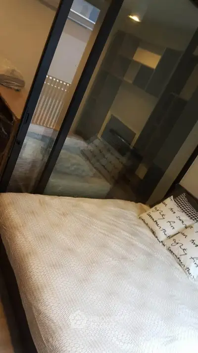 Cozy bedroom with glass partition and modern decor