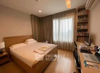 Spacious bedroom with wooden flooring, large window, and study desk, perfect for modern living.