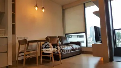 Modern living room with sleek furniture and ample natural light, featuring a cozy seating area and a stylish dining set, complemented by a warm wooden floor.