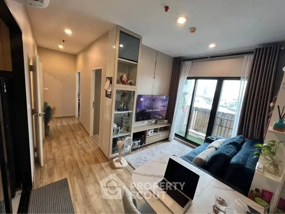 Modern living room with balcony view, stylish decor, and open layout in a contemporary apartment.