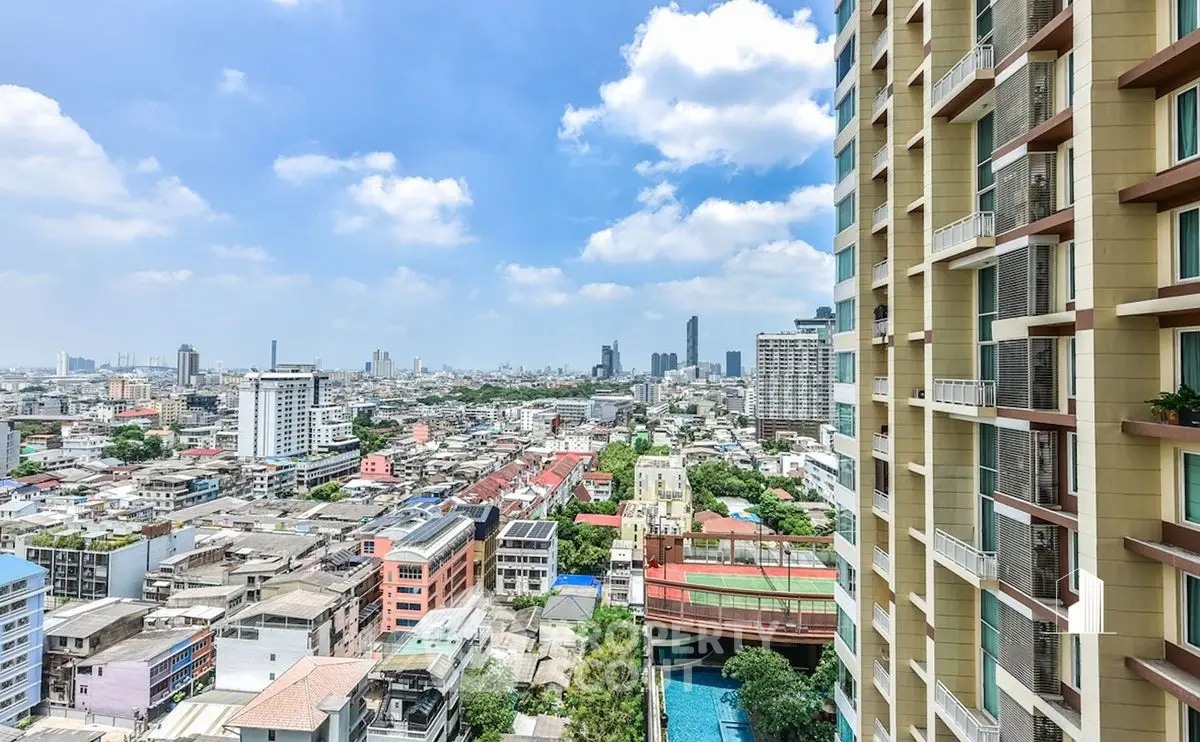 Stunning cityscape view from high-rise building balcony in vibrant urban area.