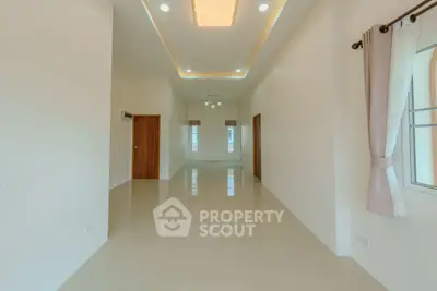 Spacious empty room with glossy tiled floors and modern lighting