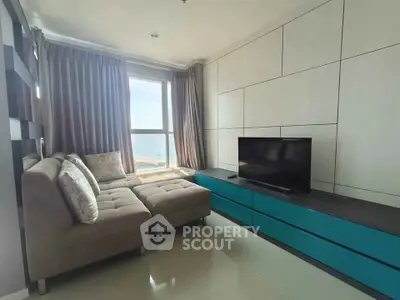 Modern living room with ocean view, stylish furniture, and natural light.