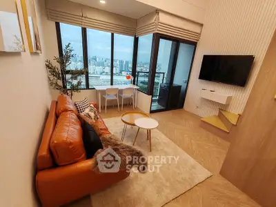 Modern living room with stunning city view, featuring cozy leather sofa and wall-mounted TV.