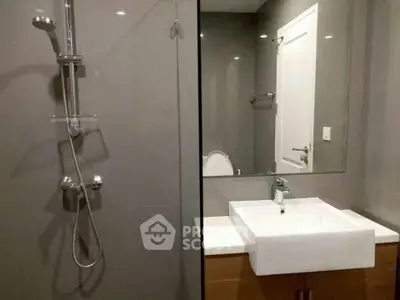 Modern bathroom with sleek fixtures and glass shower enclosure