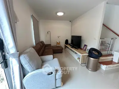 Cozy living room with modern furniture and entertainment setup, perfect for relaxation and family gatherings.