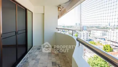 Spacious balcony with city view and safety netting, perfect for relaxation and enjoying the skyline.