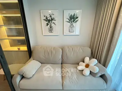 Cozy living room with beige sofa and floral decor, perfect for relaxation.