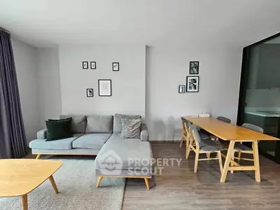 Modern living room with stylish furniture and dining area, perfect for contemporary living.