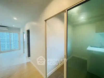 Modern apartment interior with sliding glass door and bright living area