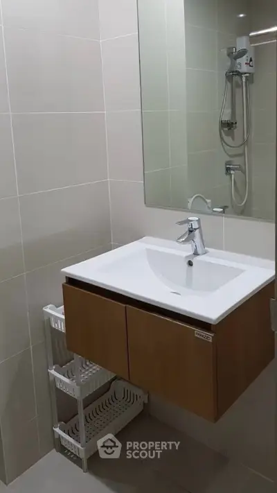 Modern bathroom with sleek vanity and shower in contemporary apartment.