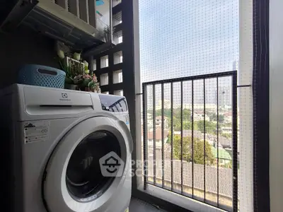 Compact balcony with washing machine and city view, perfect for urban living.