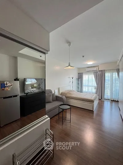 Modern studio apartment with cozy bed and natural light